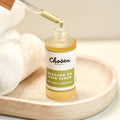 Chosen Beauty Avocado Oil Hair Serum Bottle with Dropper showing a drop 