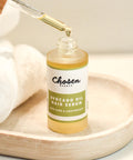 Chosen Beauty Avocado Oil Hair Serum Bottle with Dropper showing a drop 